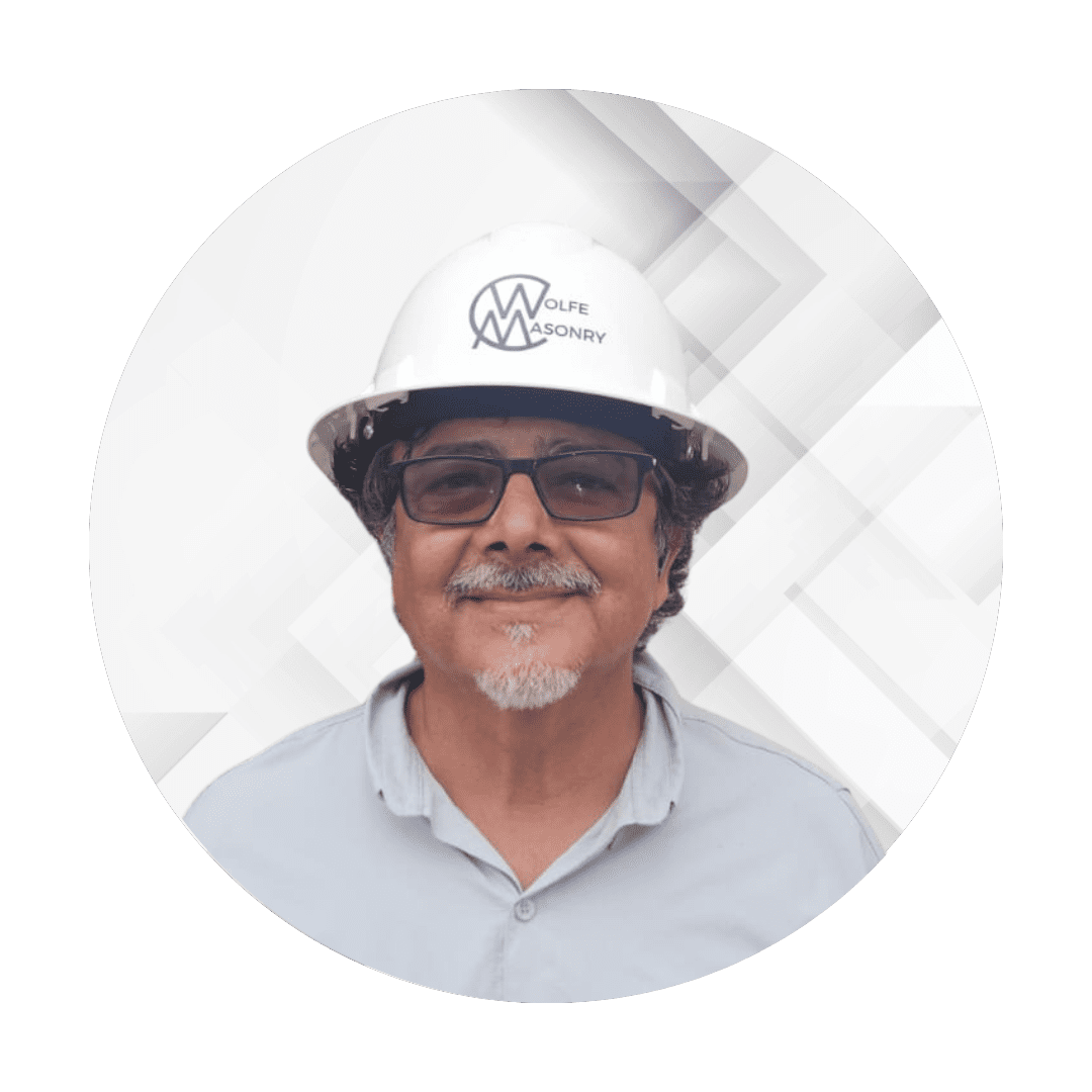 A man wearing a hard hat and glasses.
