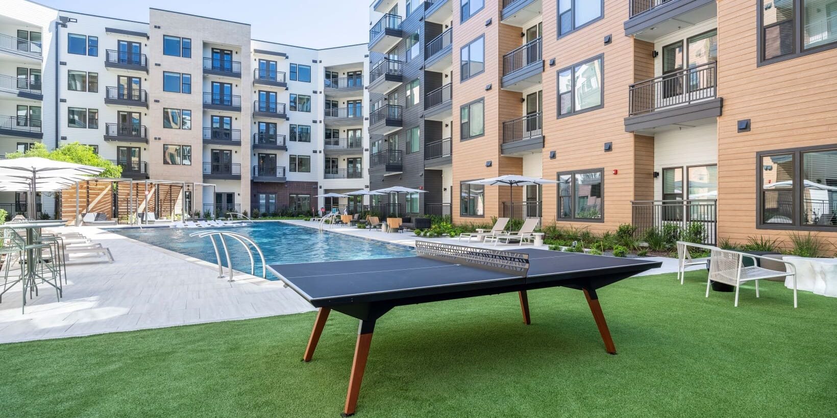 A ping pong table in the middle of an apartment complex.